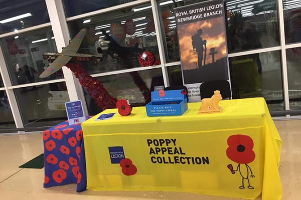The Royal British Legion's Poppy Appeal stand in Pontllanfraith Sainsbury's, with John's Lancaster bomber in the background