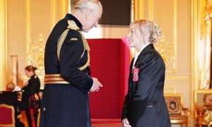 King Charles III presents Lauren Price with her MBE