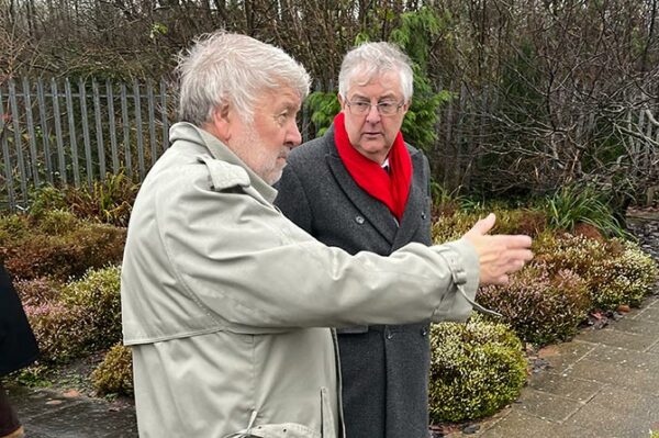 First Minister Mark Drakeford, right, at the National Mining Memorial in Senghenydd with broadcaster Roy Noble