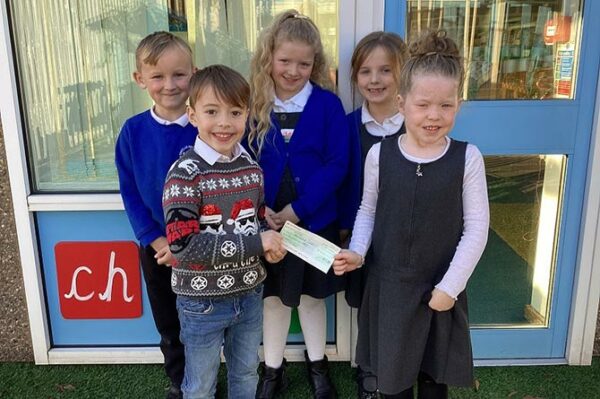 Cwm Glas Primary School pupils with a cheque for £250