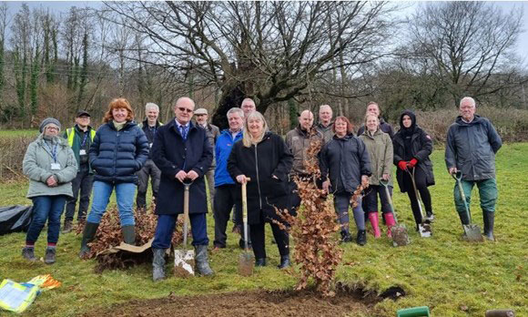 Julie James planting a tree at the commemorative woodland 