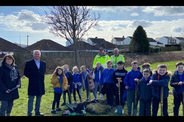 Council leader and Nelson ward councillor Sean Morgan with Llancaeach Junior School pupils and staff at the new community orchard