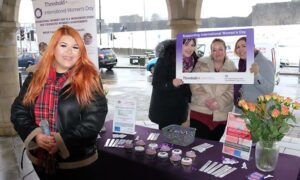 Singer Kaylee Equeall, left, performed at Threshold DAS's International Women's Day event