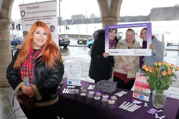 Singer Kaylee Equeall, left, performed at Threshold DAS's International Women's Day event