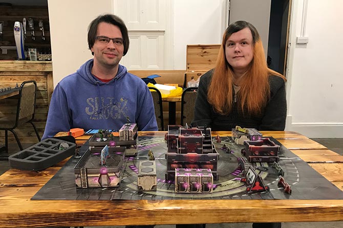Anthony Meyrick, left, and Ben Cooper playing the Infinity board game