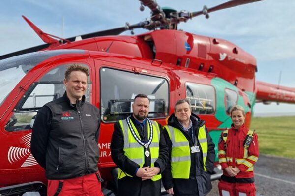 Blackwood town councillors George Edwards and Kevin Etheridge with Wales Air Ambulance crew