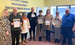 Youth Offending Service volunteers being presented with their High Sheriff awards by Malgwyn Davies