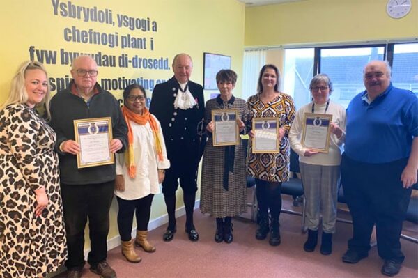 Youth Offending Service volunteers being presented with their High Sheriff awards by Malgwyn Davies