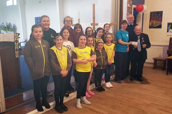 Caerphilly Lions presenting a cheque to 2nd Penyrheol Brownies