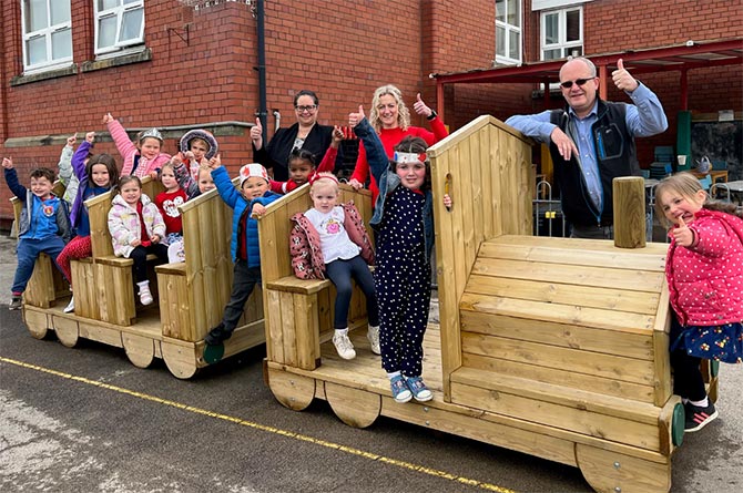 Machen Primary School pupils with their new wooden train climbing frame