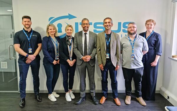 Economy minister Vaughan Gething, centre, during a visit to Cardiff-based cyber firm ITSUS