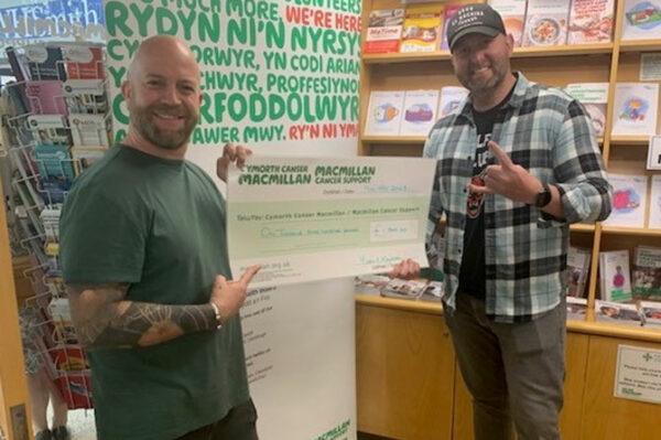 Organisers Jase Tatton and Huw Williams with a cheque for Macmillan