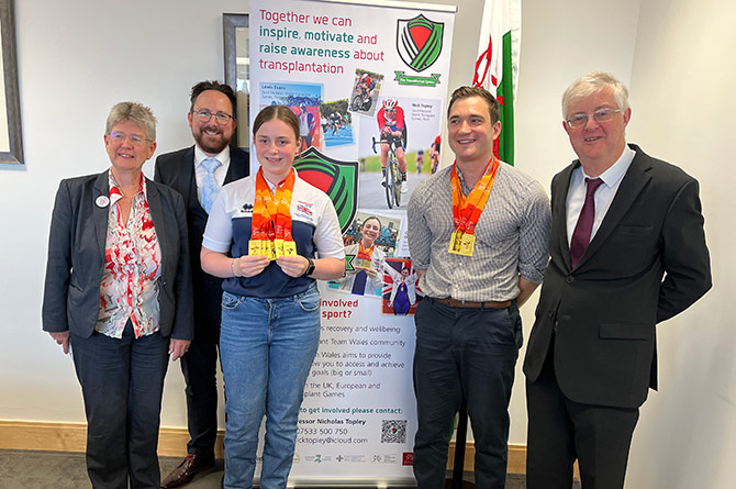 Lewis Evans visiting the Senedd after winning four gold medals in Australia