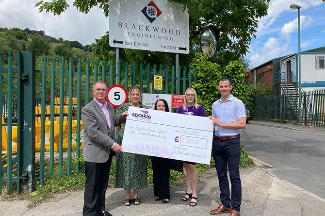 Sparkle receiving a cheque worth £8,000 from Blackwood Engineering Trust