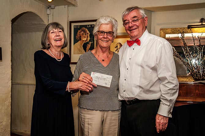 Paul and Jennifer Taylor presenting a cheque worth £350 to Macmillan