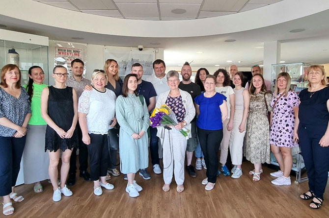 Jane Hutt MS, centre holding flowers, meeting with Ukrainians at Caerphilly Library