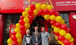 Rugby legend Shane Williams, right, with Caerphilly County Borough Council mayor Mike Adams and Mayor Consort Gloria Adams outside Pepe's
