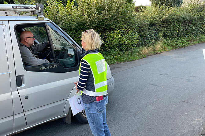 Carolyne Trinick chatting to a driver who was glad to see the group out campaigning