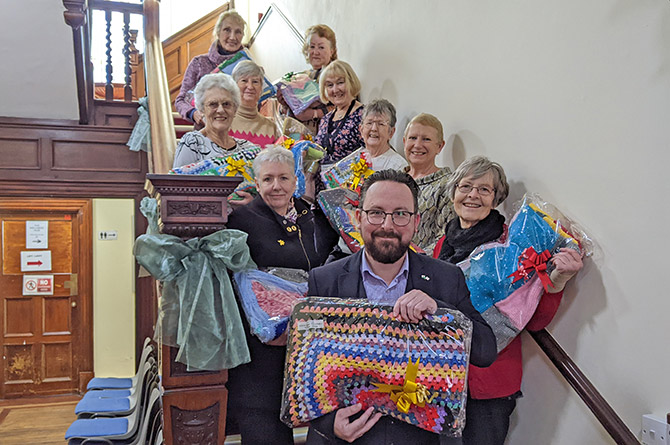 Caerphilly MS Hefin David, centre, and Caerphilly Miners' Centre volunteers and knitters