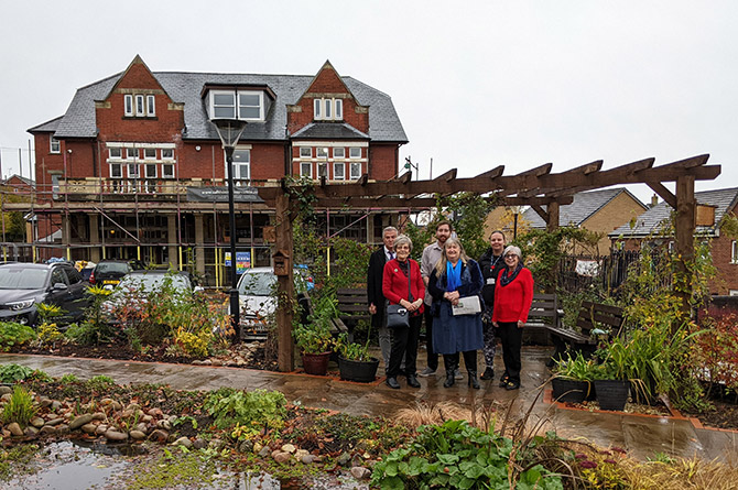 From left: Welsh Government finance manager Andrew Burke, Katherine Hughes, Caerphilly Observer's Rhys Williams, Julie James MS, Caerphilly Cares' Kirstie James, and Jenni Jones-Annetts in the centre's climate change garden