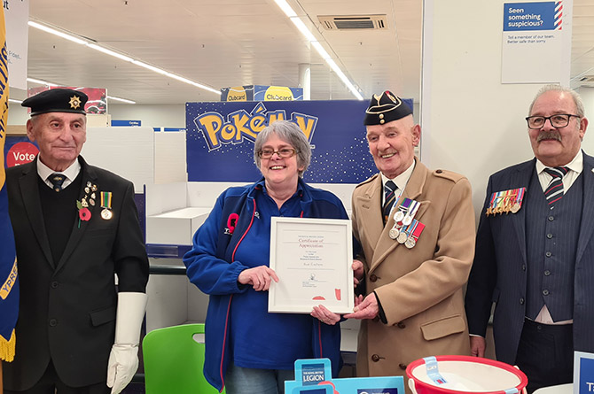 Susan Cullen receiving a certificate from members of the Royal British Legion, thanking her for her support