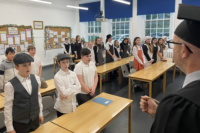 Pupils were stood in silence as Mr Thomas did his rounds