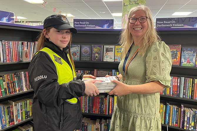 Mary Jenkins, senior library assistant at Caerphilly Library, receiving copies of the book