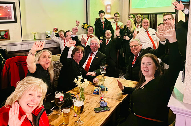 The band celebrating after qualifying for the finals later in the year