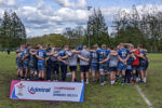 Bargoed players, coaches, and staff huddle together before the trophy presentation
