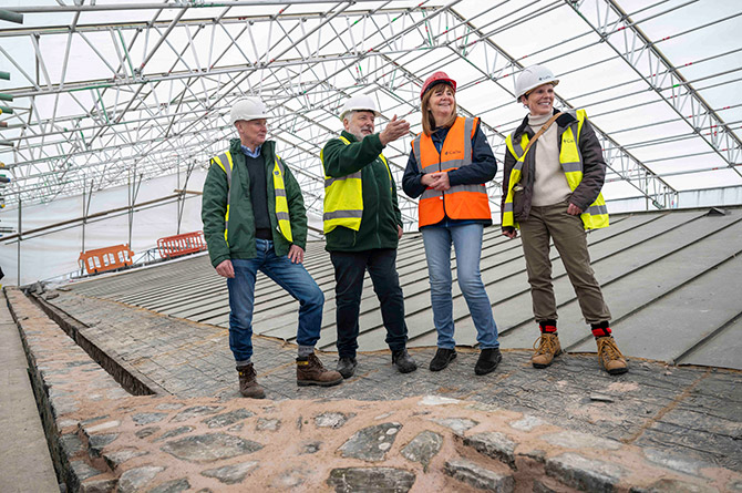 Culture secretary Lesley Griffiths, second from right, seeing the ongoing works at Caerphilly Castle