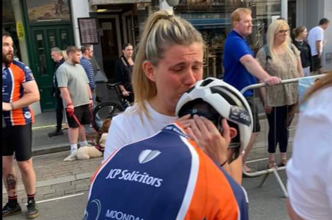 Billy is greeted by his emotional mother at the finish line
