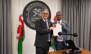 Mick Antoniw and Vaughan Gething with the royally-approved Senedd Cymru (Members and Elections) Act