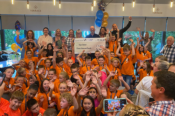 Twyn School pupils celebrating their £11,000 fundraising at Caerphilly's Ten Degrees restaurant