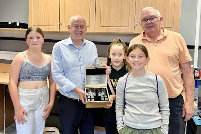 Sir Wayne David, second from left, is presented with a gift from SYDIC
