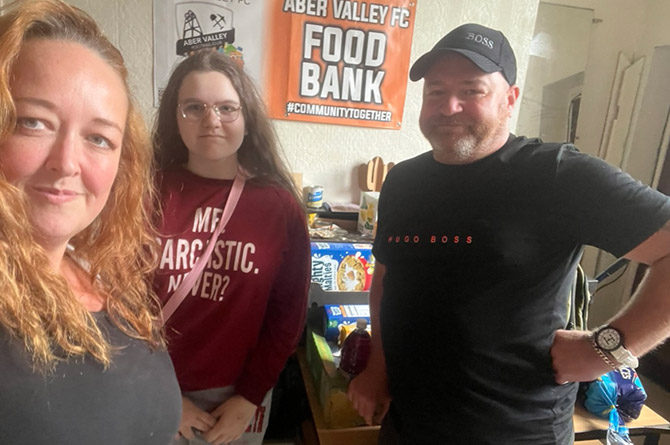 Cllr Charlotte Bishop with Rosie Mantle, centre,
and Andrew Hart from Aber Valley FC Food Bank