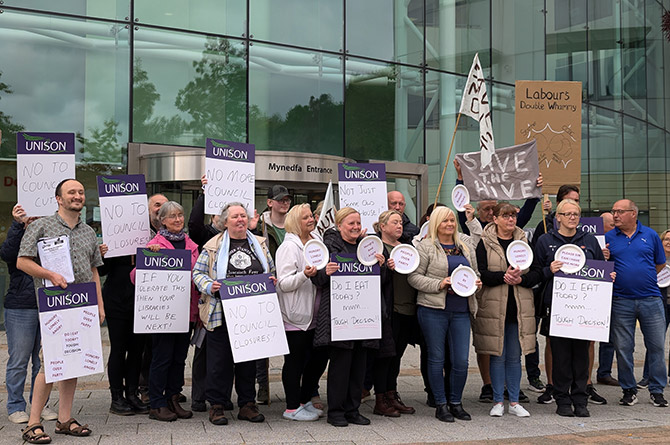 Unison members at Caerphilly County Borough Council protest outside the council offices on September 24