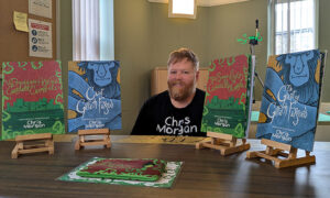 Illustrator Chris Morgan with copies of his new book
