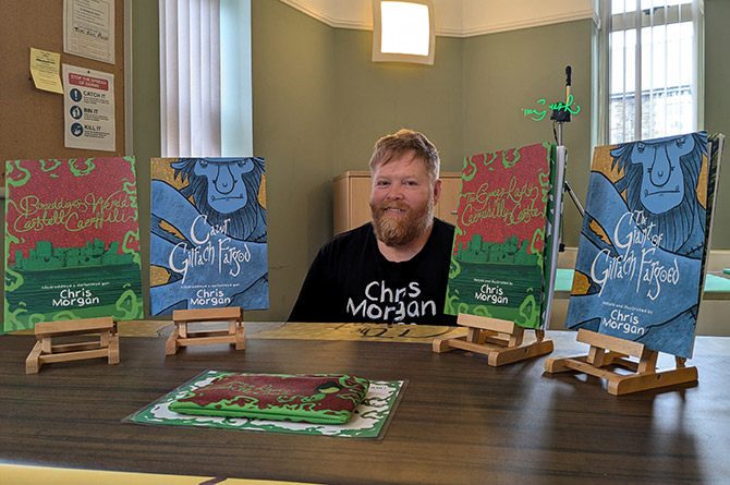 Illustrator Chris Morgan with copies of his new book