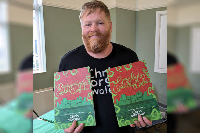 Illustrator Chris Morgan with copies of his new book