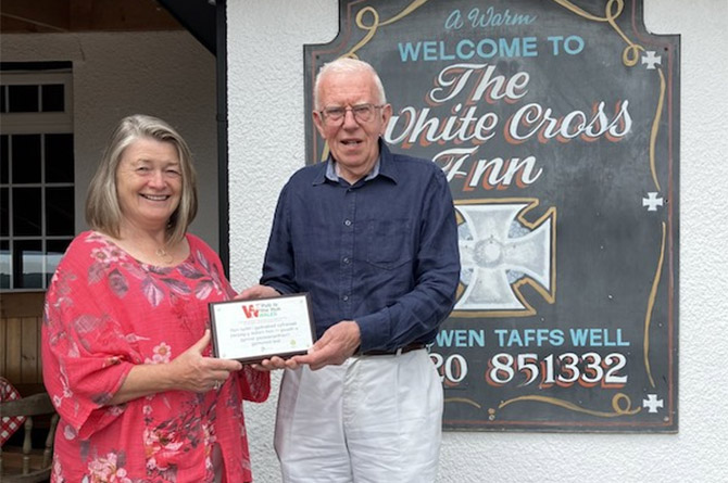 White Cross Inn landlady Mair Arthur is presented a cheque by Roger Belle, of Pub is the Hub
