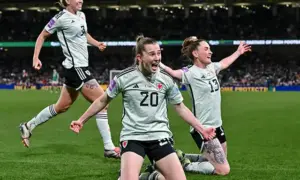 Carrie Jones (number 20) celebrating her goal with teammates