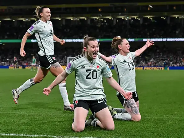 Carrie Jones (number 20) celebrating her goal with teammates