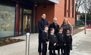 From left: Cllr Dimitri Batrouni, Cllr Deb Davies, and headteacher Jo Giles, with pupils, at the opening of the new building at St Andrews Primary School, Newport