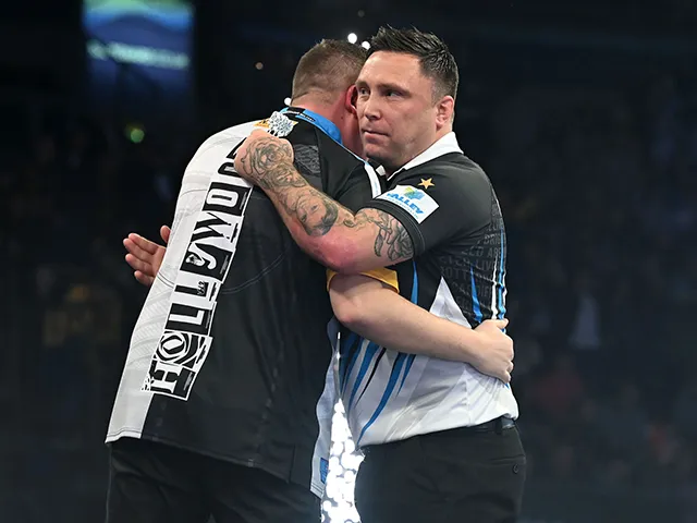 Gerwyn Price, right, embraces Chris Dobey following his quarter-final defeat