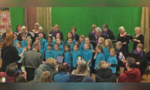 Cefn Hengoed Ladies Choir performing with Hendredenny Park Primary School pupils
