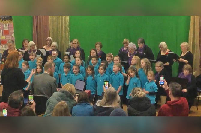 Cefn Hengoed Ladies Choir performing with Hendredenny Park Primary School pupils