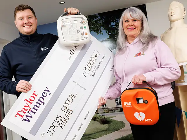 Taylor Wimpey's Matt James presents a cheque to June Thomas, founder of Jack's Appeal