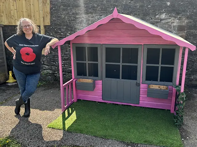 Gillian Collins, of Cardiff City FC Veterans' Hub, with the refurbished Wendy house - which was saved from being thrown out