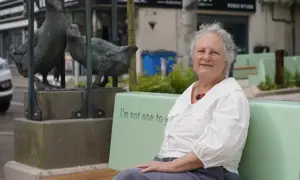 Sculptor Julie Westerman next to her gossiping geese statue at the revamped square on Windsor Street