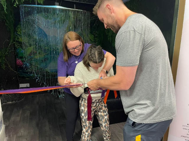 George Nott and Izzy Wilshaw open the new sensory room at Sense Hub Caerphilly, alongside Kate Wright